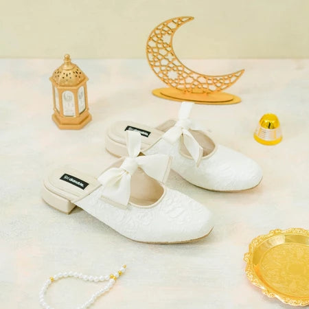 White lace shoes with bow details by Dianable on a light background