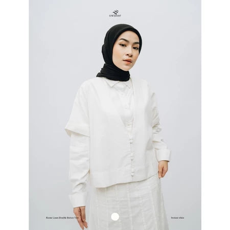 A woman wearing a 'Renee Double Button Vest' by Swifter in broken white color with a round neckline and long sleeves.