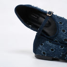A close-up of a dark blue flatshoes with a strap and gold buckle, showing the CEKHAS brand label on the insole, set against a plain white background.