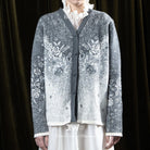 Person wearing a grey patterned cardigan by BWBYAZ over a white shirt with a dark background