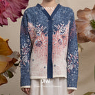 Blue cardigan with pink and white floral pattern by BWBYAZ on a floral background