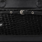 Close-up of a black textured leather handbag by Cekhas with a silver buckle.