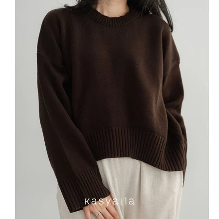 Dark brown oversized sweater worn by a person on a plain background with 'Kasyalia' branding.