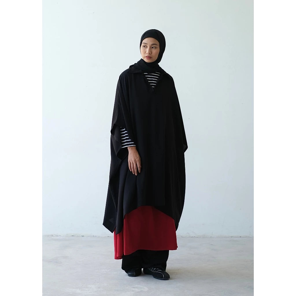 Person wearing a black vest by Rashawl with a white background