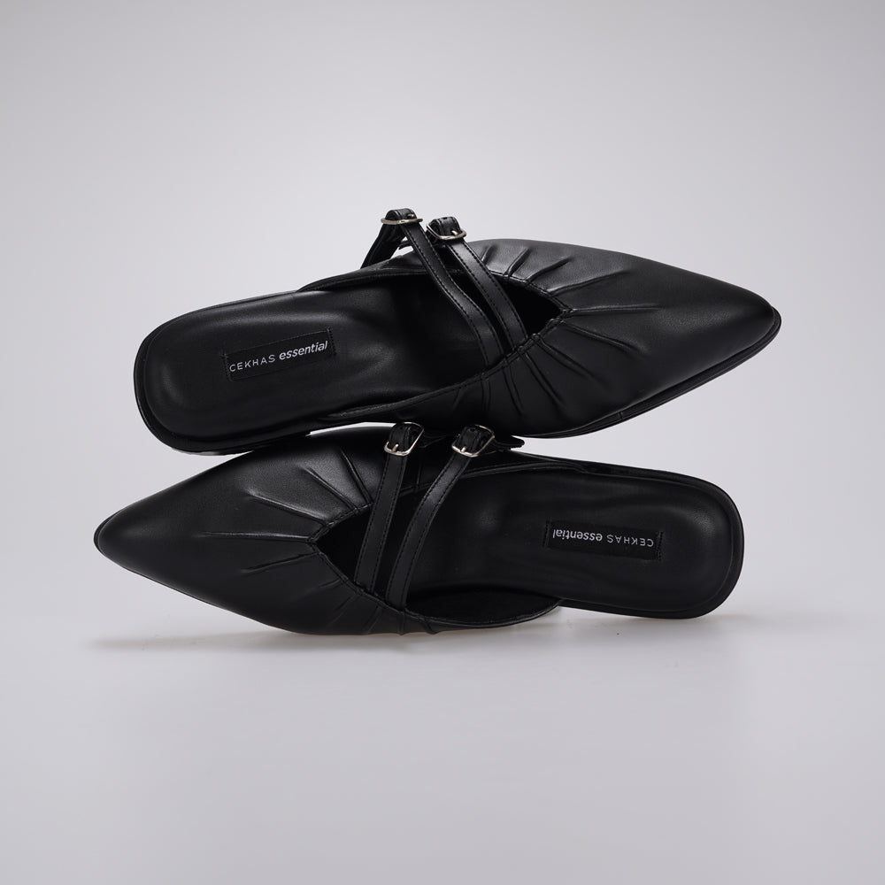 A pair of black pointed-toe mule sandals by Cekhas with double buckle straps, shown from a top-down angle on a light gray background.