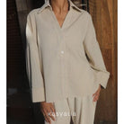Beige striped shirt by Kasyalia and pants set with a blurred background