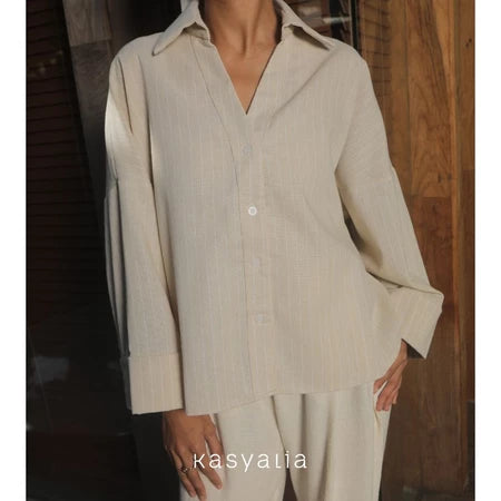 Beige striped shirt by Kasyalia and pants set with a blurred background