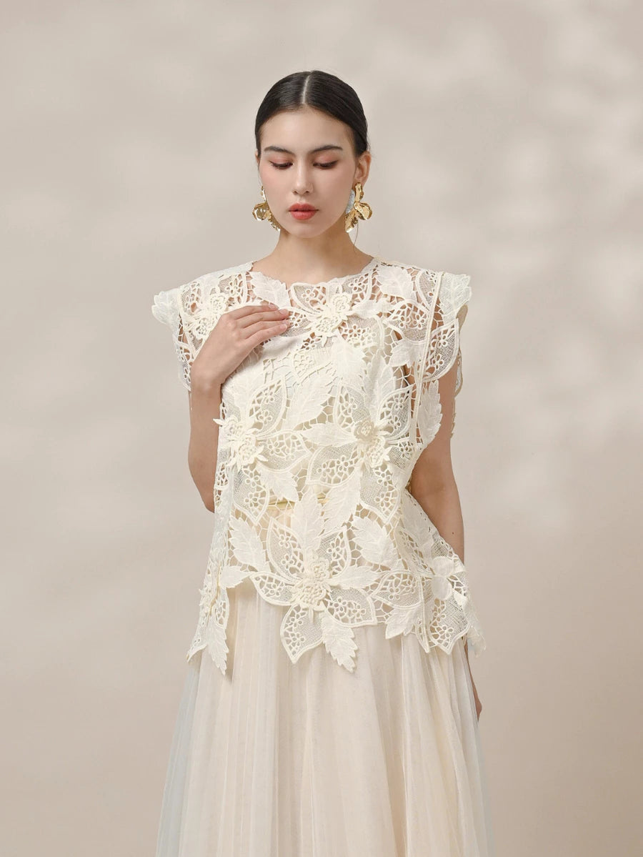 Woman wearing a beige lace vest by Kasa Heritage against a plain background