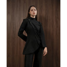 Woman wearing a black blouse by Kasa Heritage against a wooden background