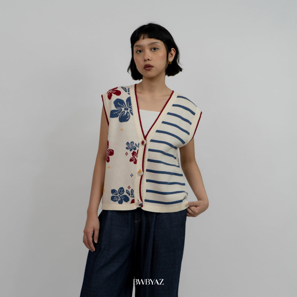 A person wearing a sleeveless cotton knit vest with a combination of floral and striped patterns, in beige, red, and blue colors from BWBYAZ.