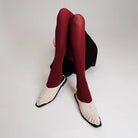 Red tights and ivory Vonee Mules flat shoes by Cekhas on a white background