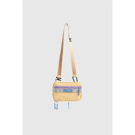 Small yellow crossbody bag with a strap from Muhajir Project on a light gray background