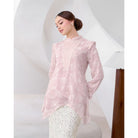 Woman wearing a light pink blouse by Kasa Heritage with a white background