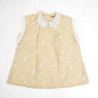Beige checkered blouse by Holy Peony with white lace collar and sleeves on a white background